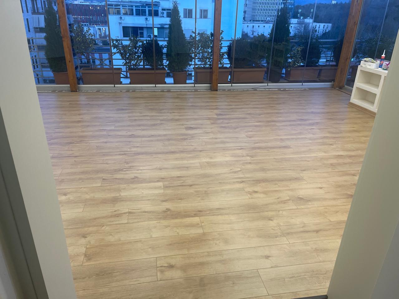 Laminat lisi në taracë të mbyllur me pamje qyteti